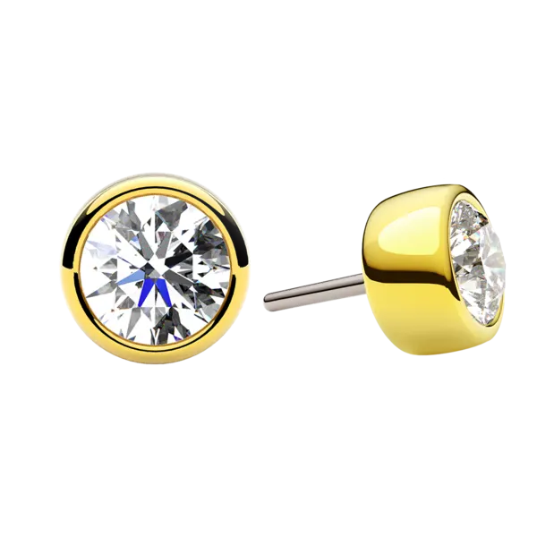 Single hand-set faceted CZ in a polished solid-gold bezel — a quiet everyday gem end